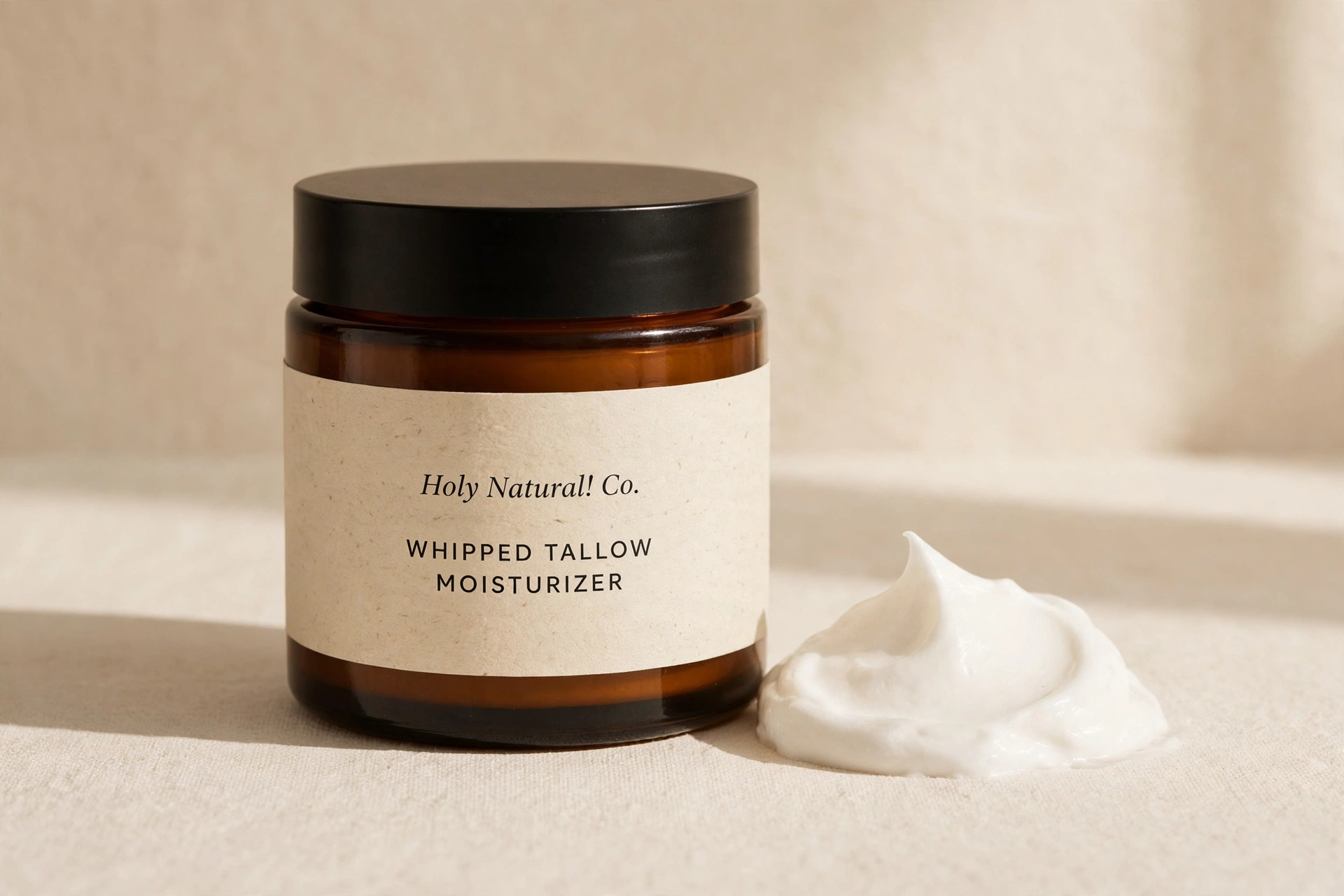Whipped Tallow Moisturizer in an amber glass jar with a dollop of cream